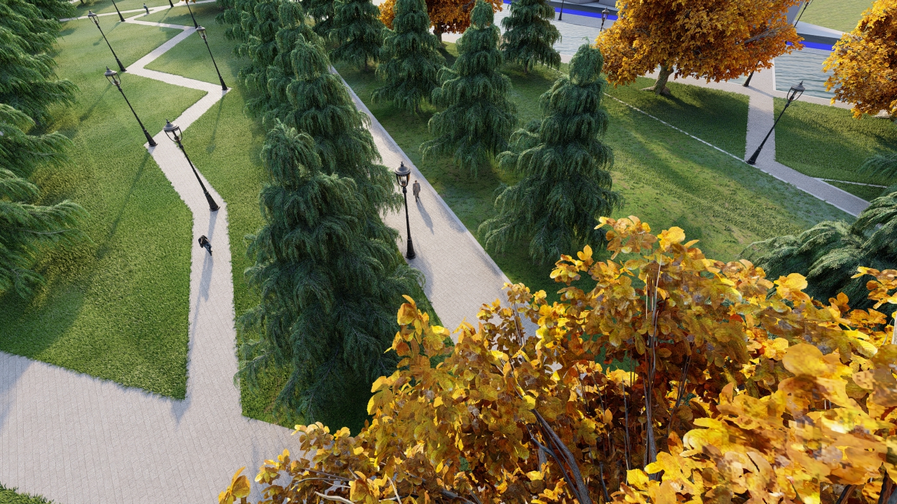 Yürüyüş yolları arasında konumlanmış yeşil ve turuncu yapraklı ağaçların bulunduğu park alanı.