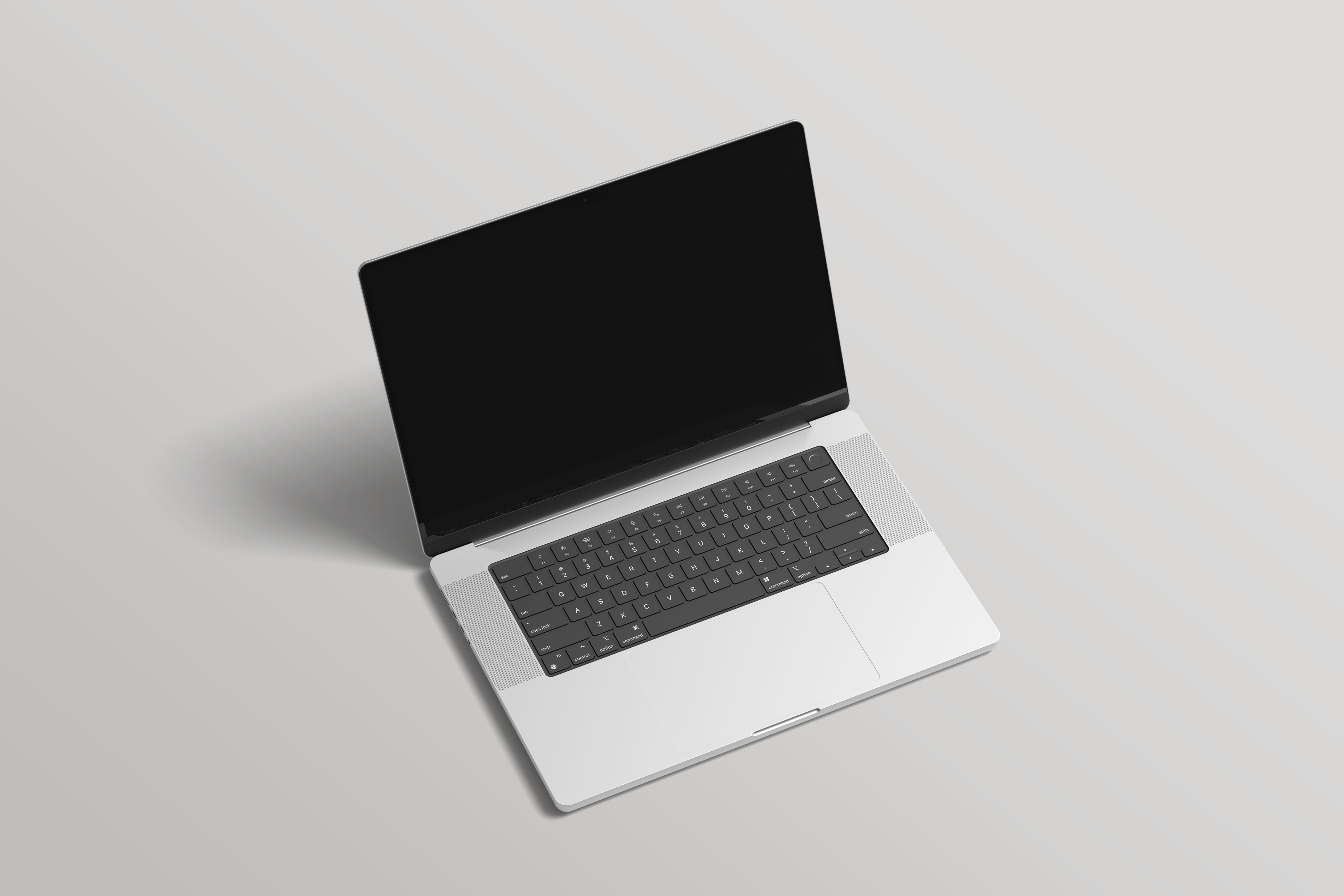Gri arka planda açık gri bir yüzeye yerleştirilmiş, siyah klavyeli açık gümüş renkli dizüstü bilgisayar.